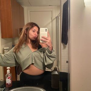 Olive green zip up sweater with a hood